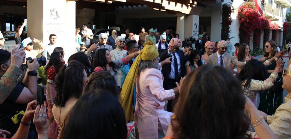 DJ Justin Warwick owner of DJ Enterprises Mobile Disc Jockey with his premium battery powered 1,200 Watt mobile sound system for an Indian Baraat Procession in Monterey California. The Monterey Plaza Hotel | with wedding DJ Justin Warwick of DJ Enterprises Mobile Disc Jockey in Monterey CA | Modern wedding ceremony and reception in Monterey, Carmel, and the Santa Cruz CA area | Monterey wedding DJs | Carmel wedding DJs | Santa Cruz wedding DJs | Big Sur wedding DJs | Premium Mobile Baraat Sound System