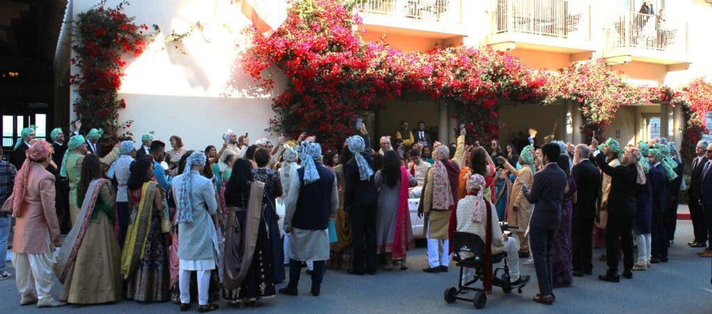 DJ Justin Warwick owner of DJ Enterprises Mobile Disc Jockey with his premium battery powered 1,200 Watt mobile sound system for an Indian Baraat Procession in Monterey California. The Monterey Plaza Hotel | with wedding DJ Justin Warwick of DJ Enterprises Mobile Disc Jockey in Monterey CA | Modern wedding ceremony and reception in Monterey, Carmel, and the Santa Cruz CA area | Monterey wedding DJs | Carmel wedding DJs | Santa Cruz wedding DJs | Big Sur wedding DJs | Premium Mobile Baraat Sound System