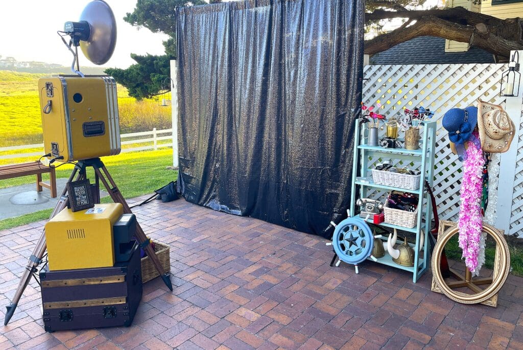 Vintage Wedding Photo Booth, Prop Display and Black backdrop at the Mission Ranch in Carmel-by-the-Sea, California. Awesome Sauce Photo Booth rental provided by DJ Enterprises Mobile Disc Jockey in Monterey, California.