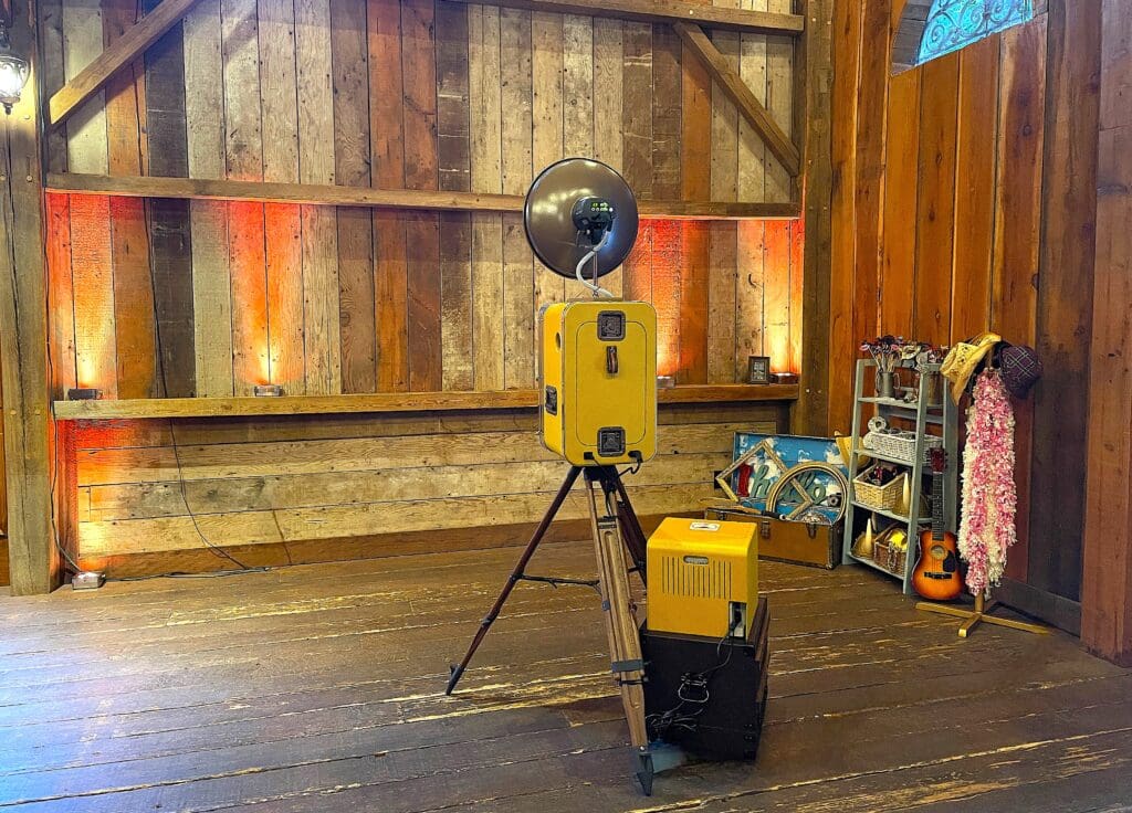 Classic Vintage style photo booth at the Waterfall Lodge in Ben Lomond, California. Barn wood backdrop with retro wedding photo booth props. Awesome Sauce Photo Booth provided by DJ Enterprises Mobile Disc Jockey